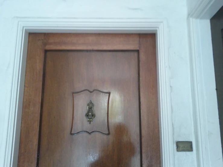 a wood door with a sign in it