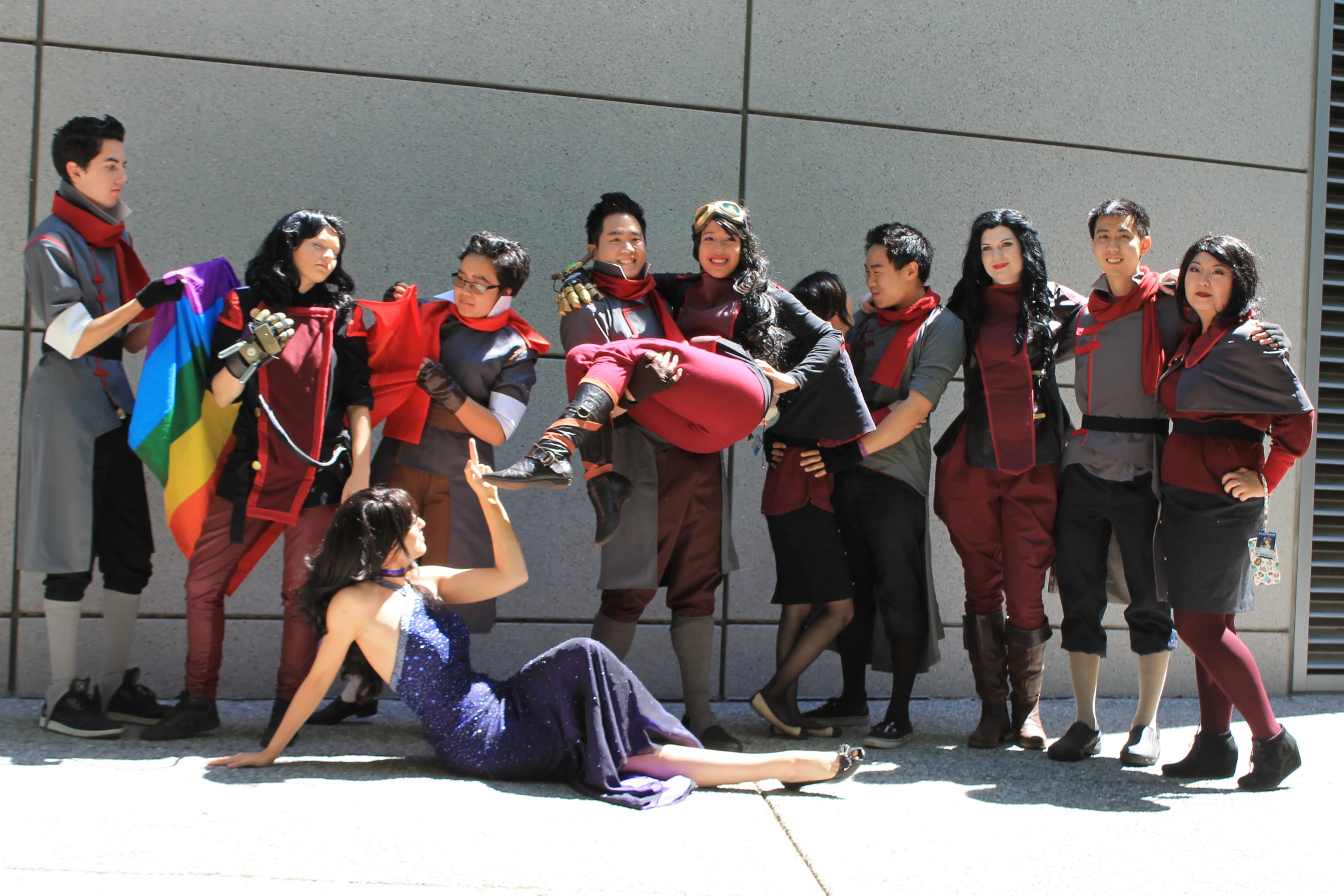 young people in cosplay standing around a woman on the ground