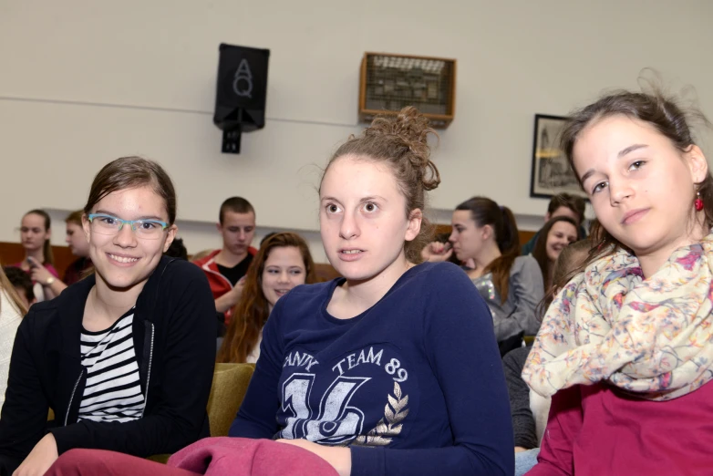 three s sitting down in chairs at a meeting