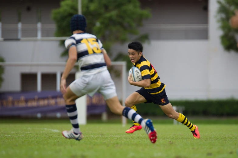 a rugby player running with the ball as other players run beside him