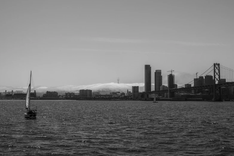 a sail boat sailing on top of a large body of water