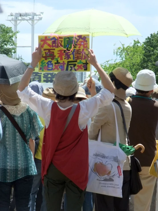 some people are wearing hats and holding signs