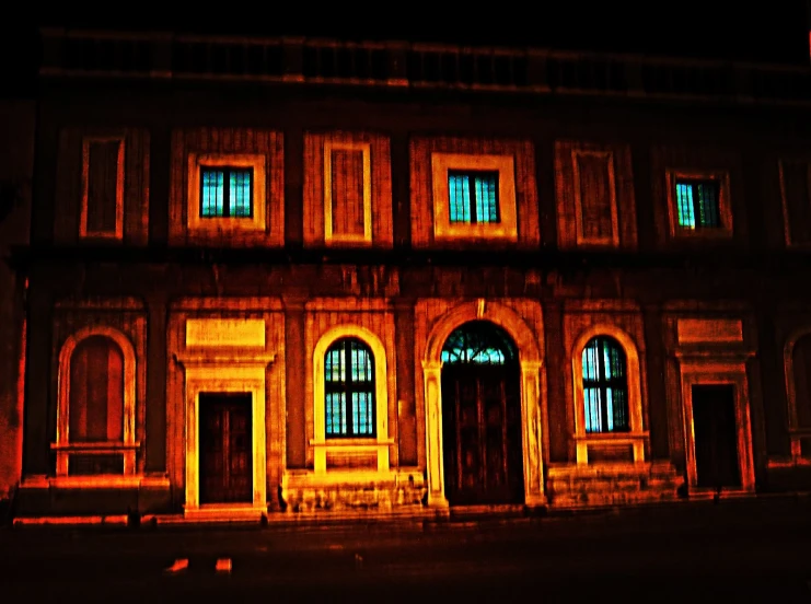 an old building with windows in the middle of the night