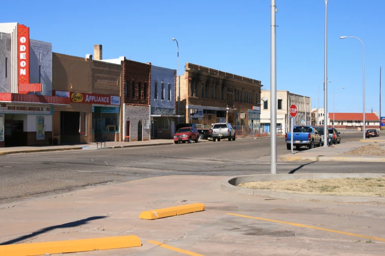 a street scene with cars parked on the curb