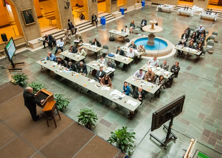 an overhead view of people sitting at tables in a room