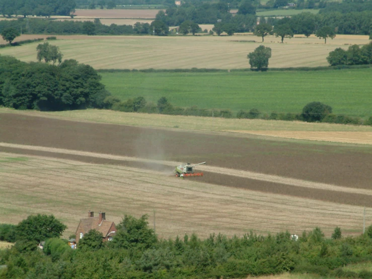 a crop cropper plows through a harvested field