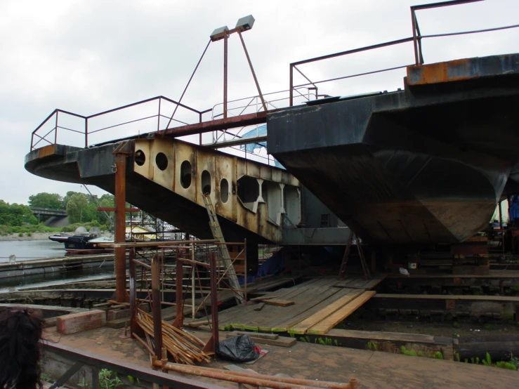 an old rusted bridge sits empty near the river