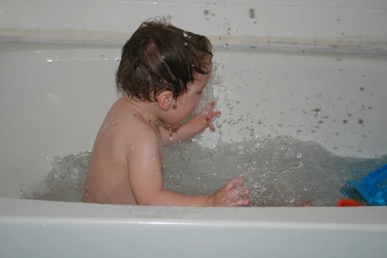 a baby who is sitting in the tub