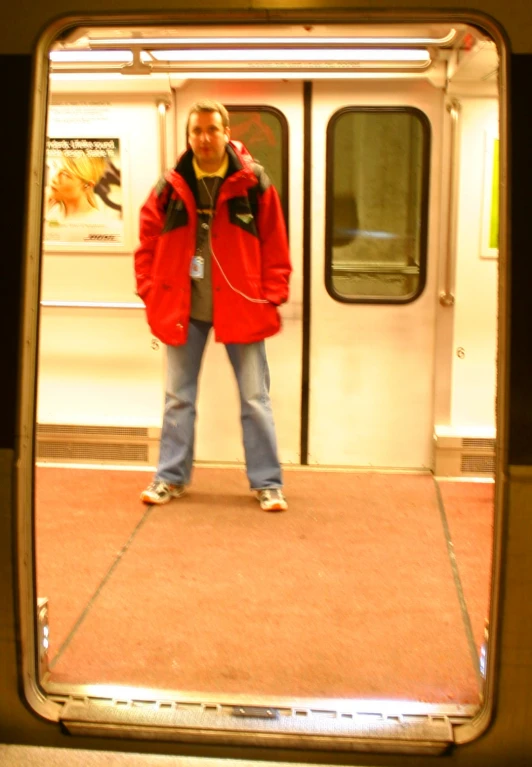 a woman standing at the door to the subway car