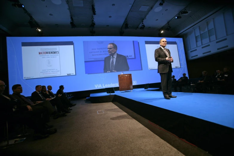 a man on a stage with a podium on the side