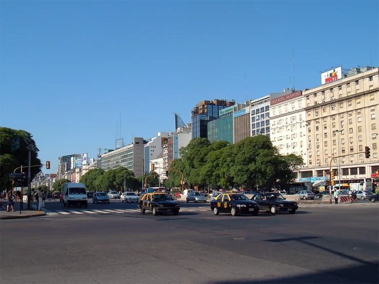 several police cars and trucks on a city street