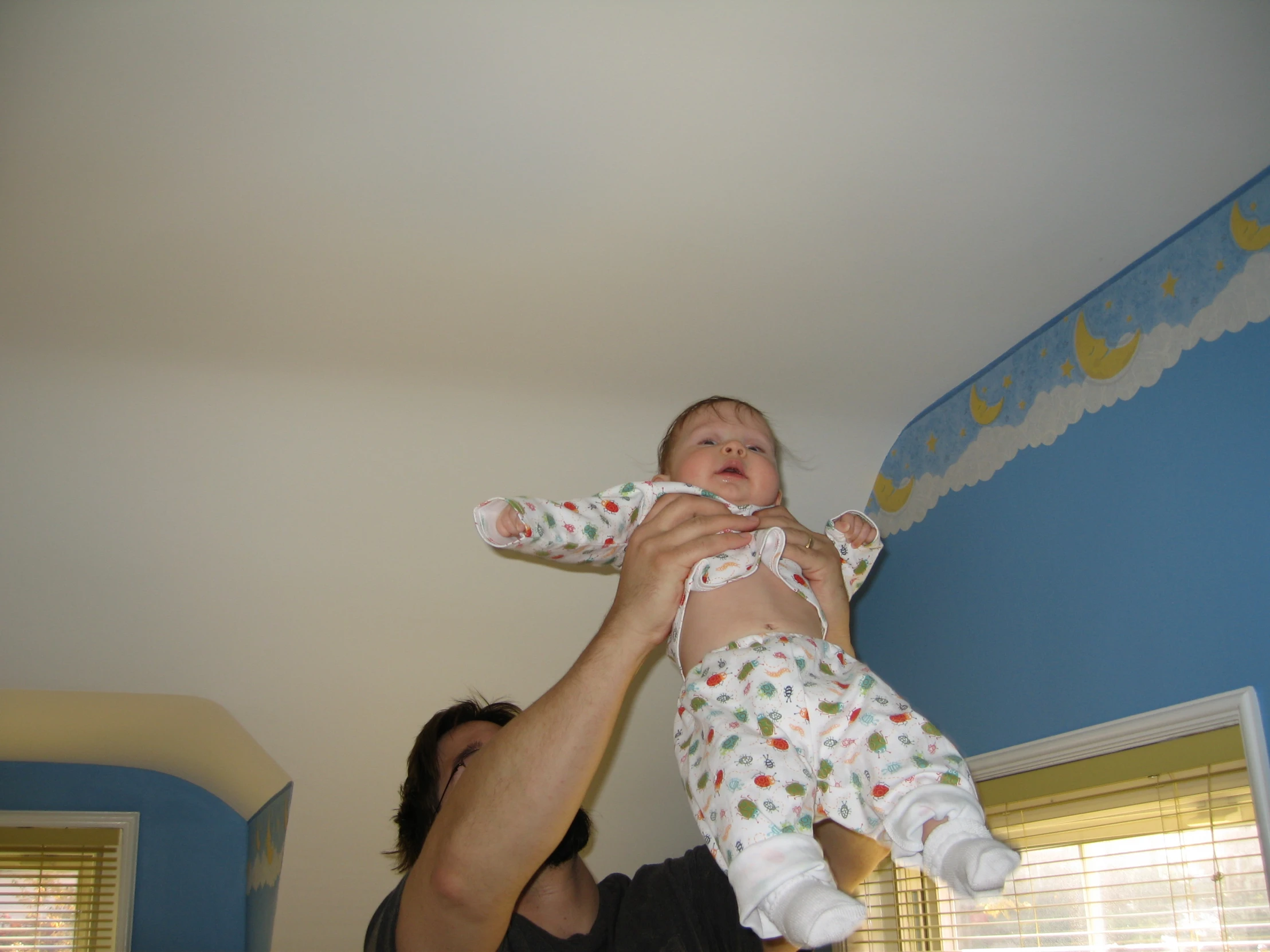 a man and child are playing with a wii remote