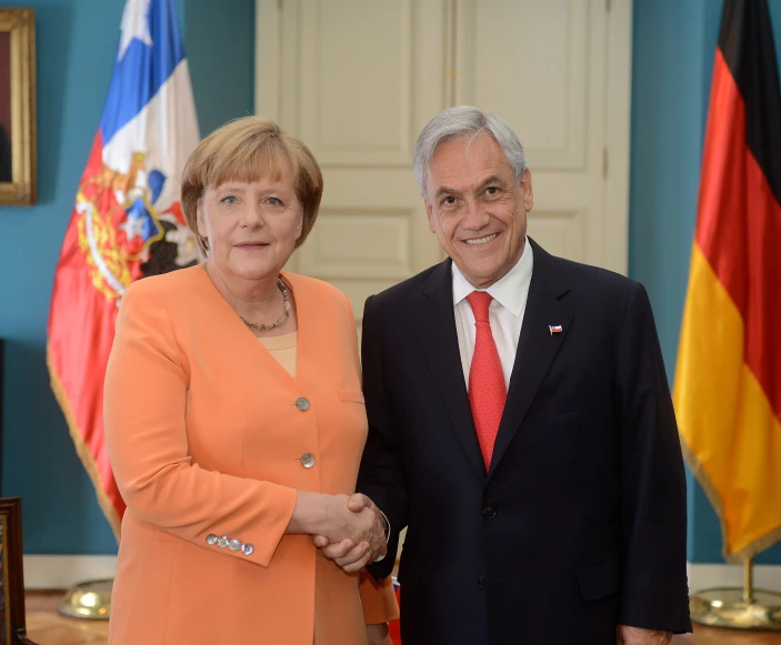 a person in a suit and tie standing next to another person