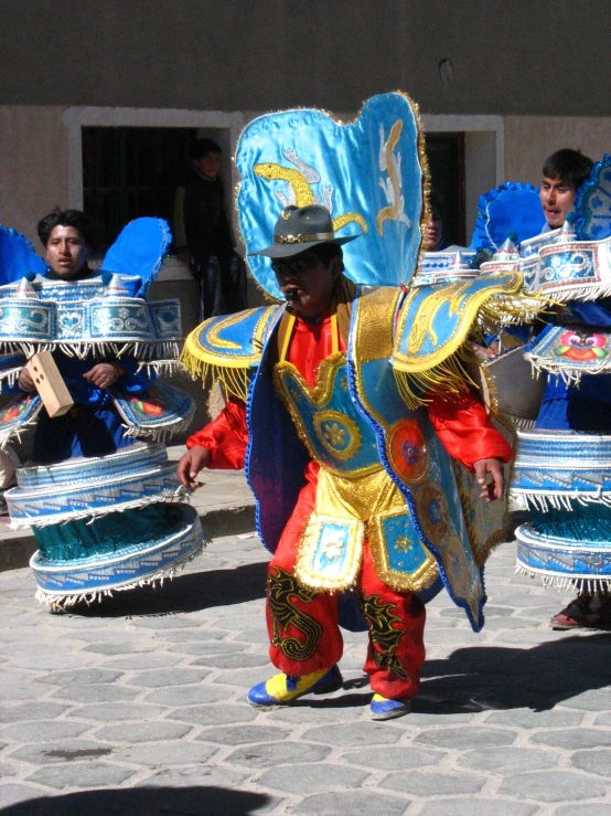 a group of people with costumes playing drums