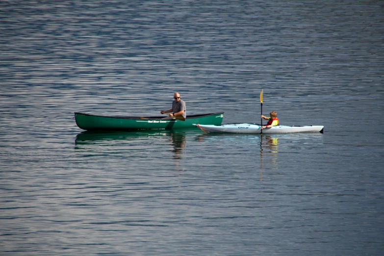 two people in canoes on the water