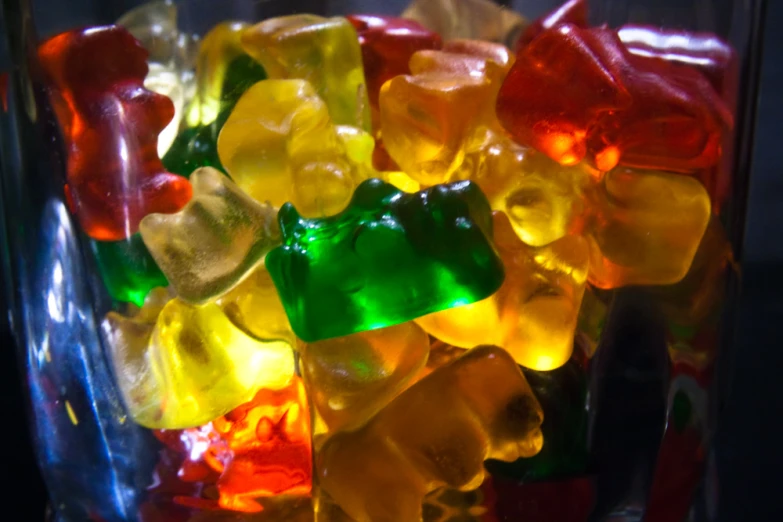 gummy bears are arranged in a clear vase