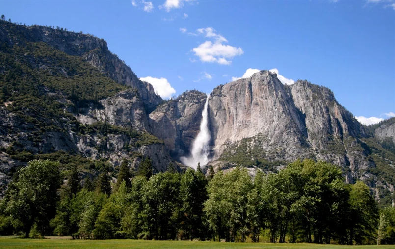 a view of some tall waterfall from below