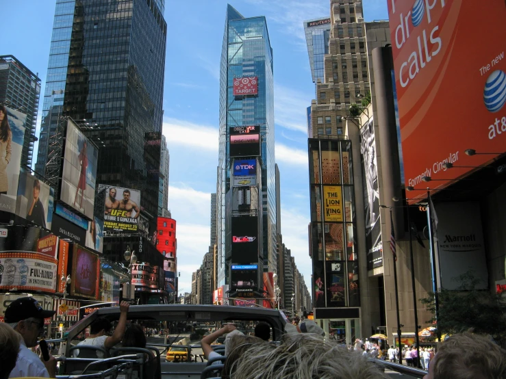 a crowded street filled with billboards, buildings and lots of pedestrians