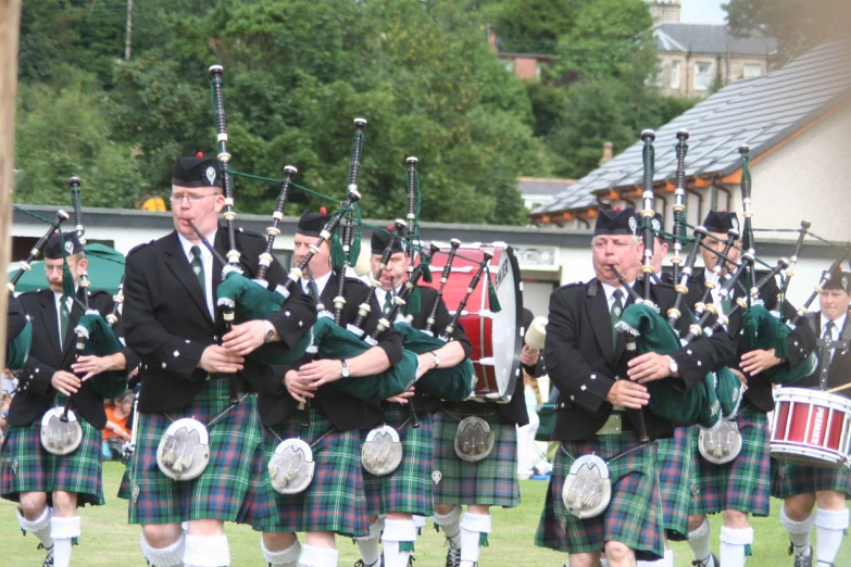 a group of men in kilts standing next to each other