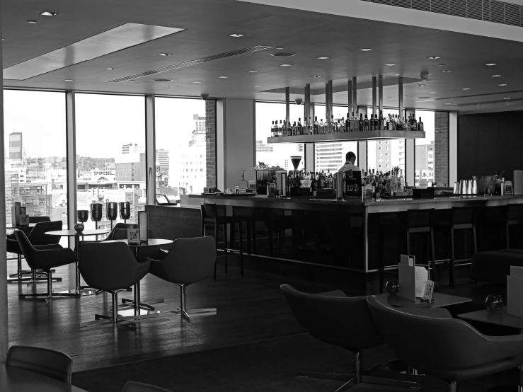 a room filled with furniture and windows next to a bar