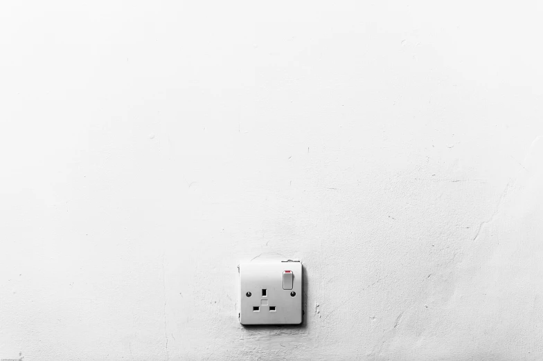 a close up view of the outlets in a white wall