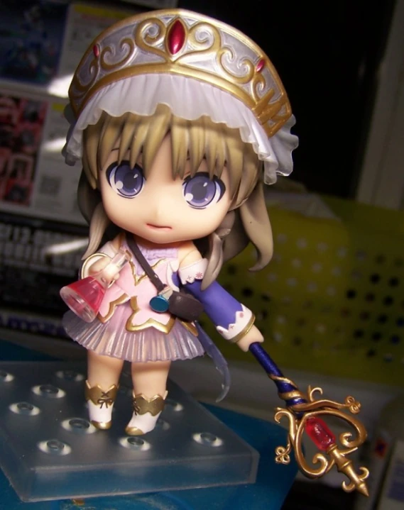 a figurine doll with an elaborately decorated hat and key