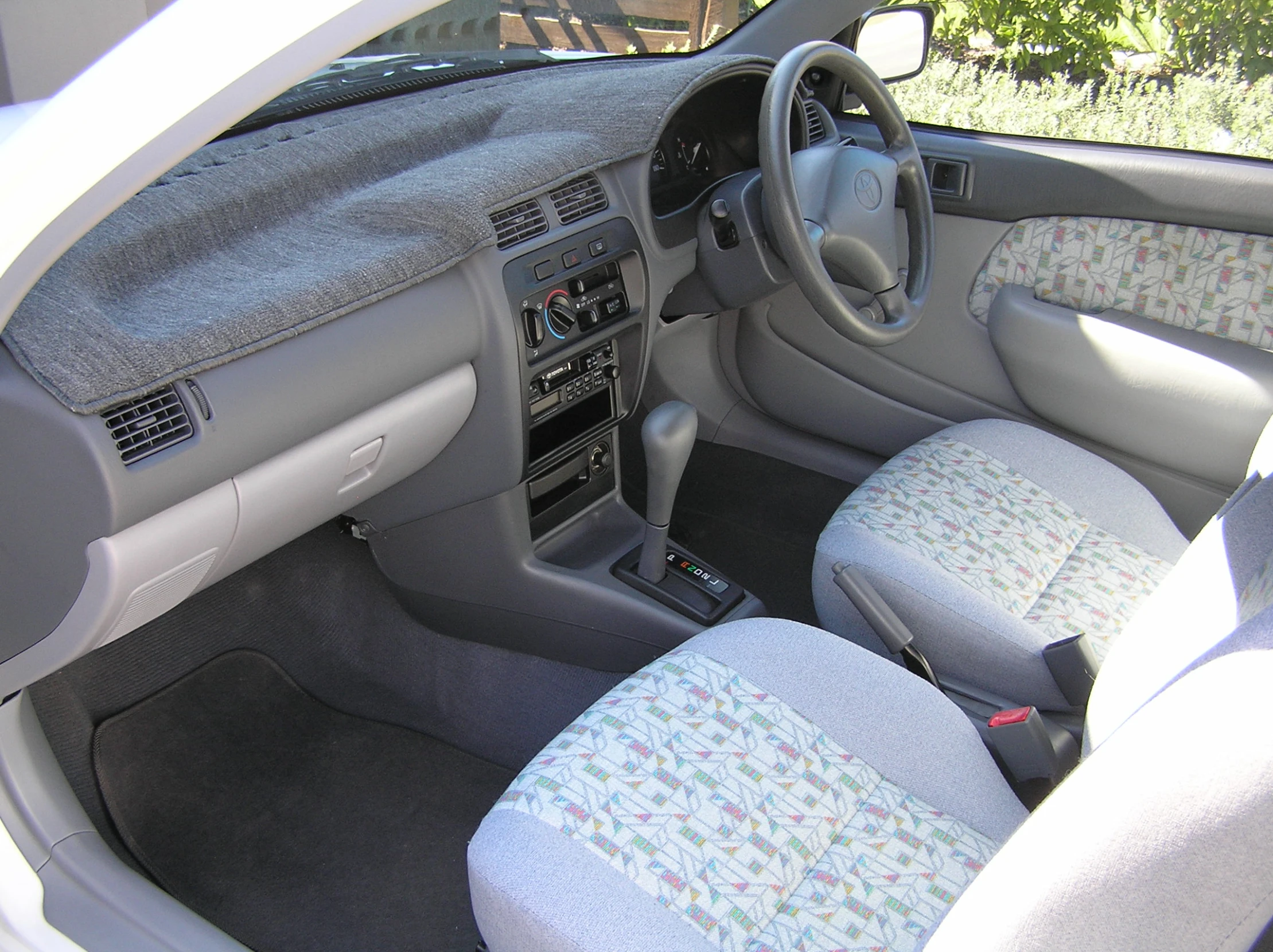 a white car dashboard with blue seats in it