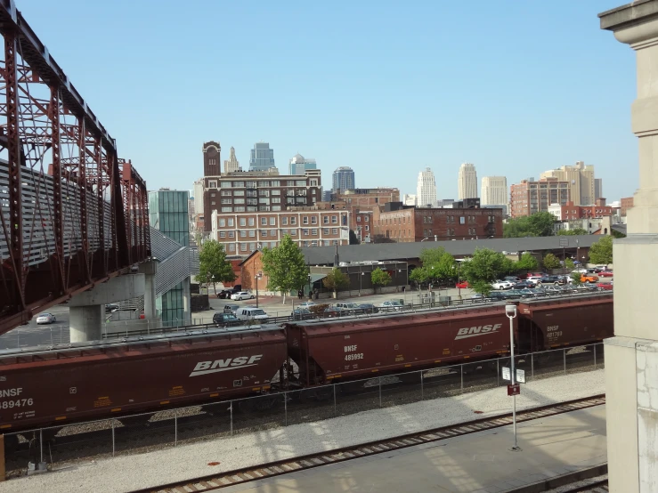 a train on a train track with a city in the background