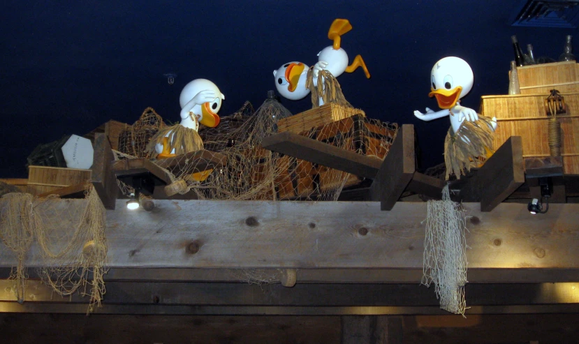 a group of small birds hanging from the side of a boat