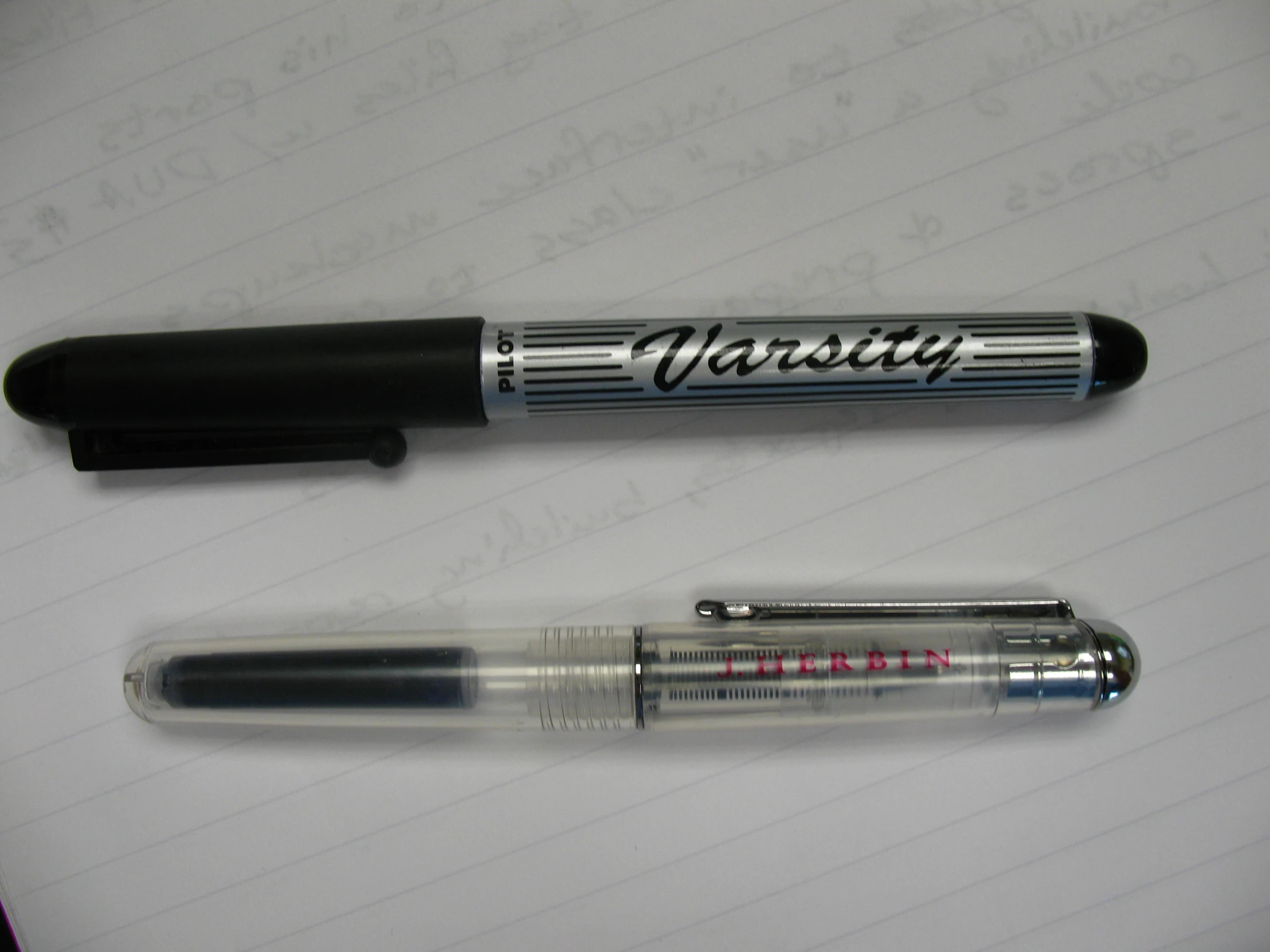 a close up of two pens on a table