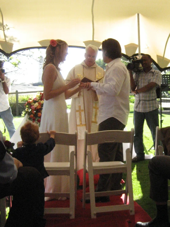 several people are standing in small chairs outside