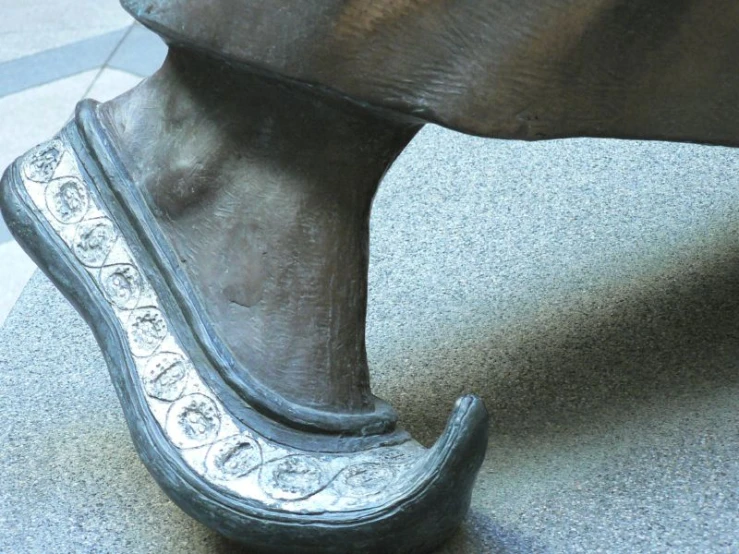 a close up of a shoe on a stone ground