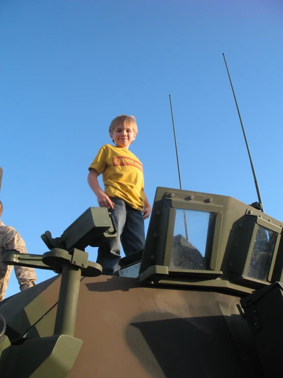  standing on top of military equipment