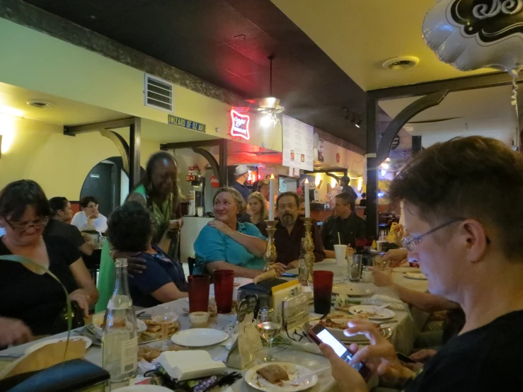 people sitting around eating at a restaurant together