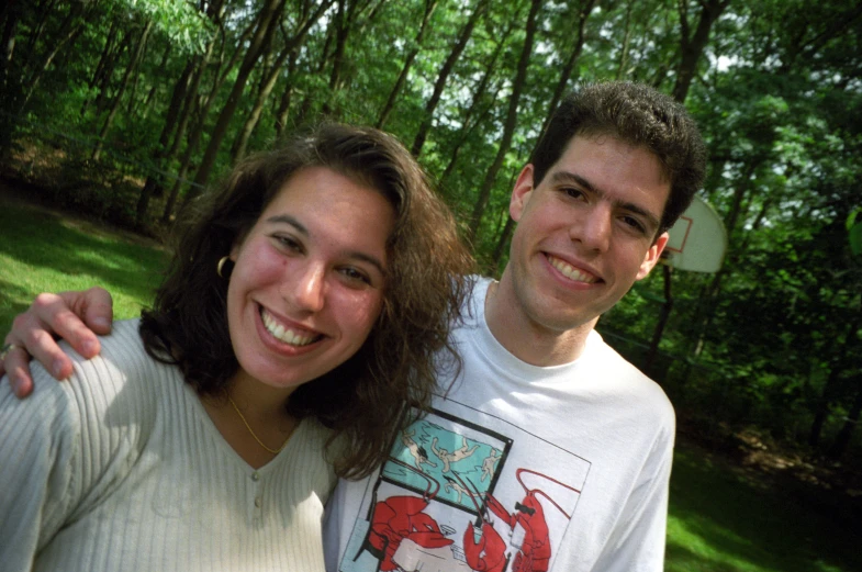 two smiling people are posing for the camera