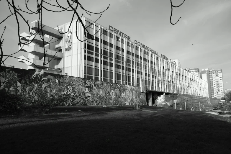 a large building sitting on top of a lush green field