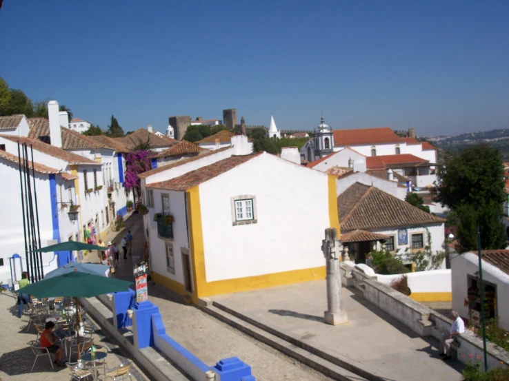 two story white buildings with yellow trim