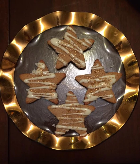 a round plate with several shaped cookies on it