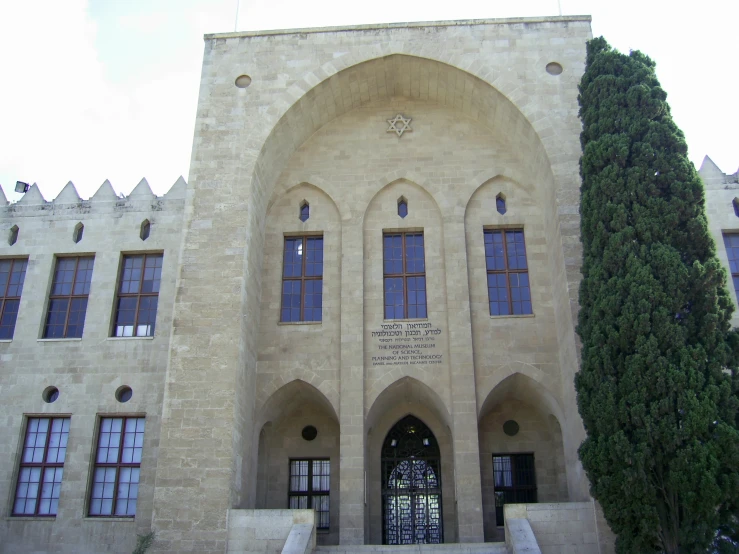 an entrance to the large building with a clock above the door