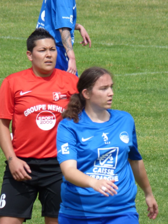 two soccer players look away from the camera