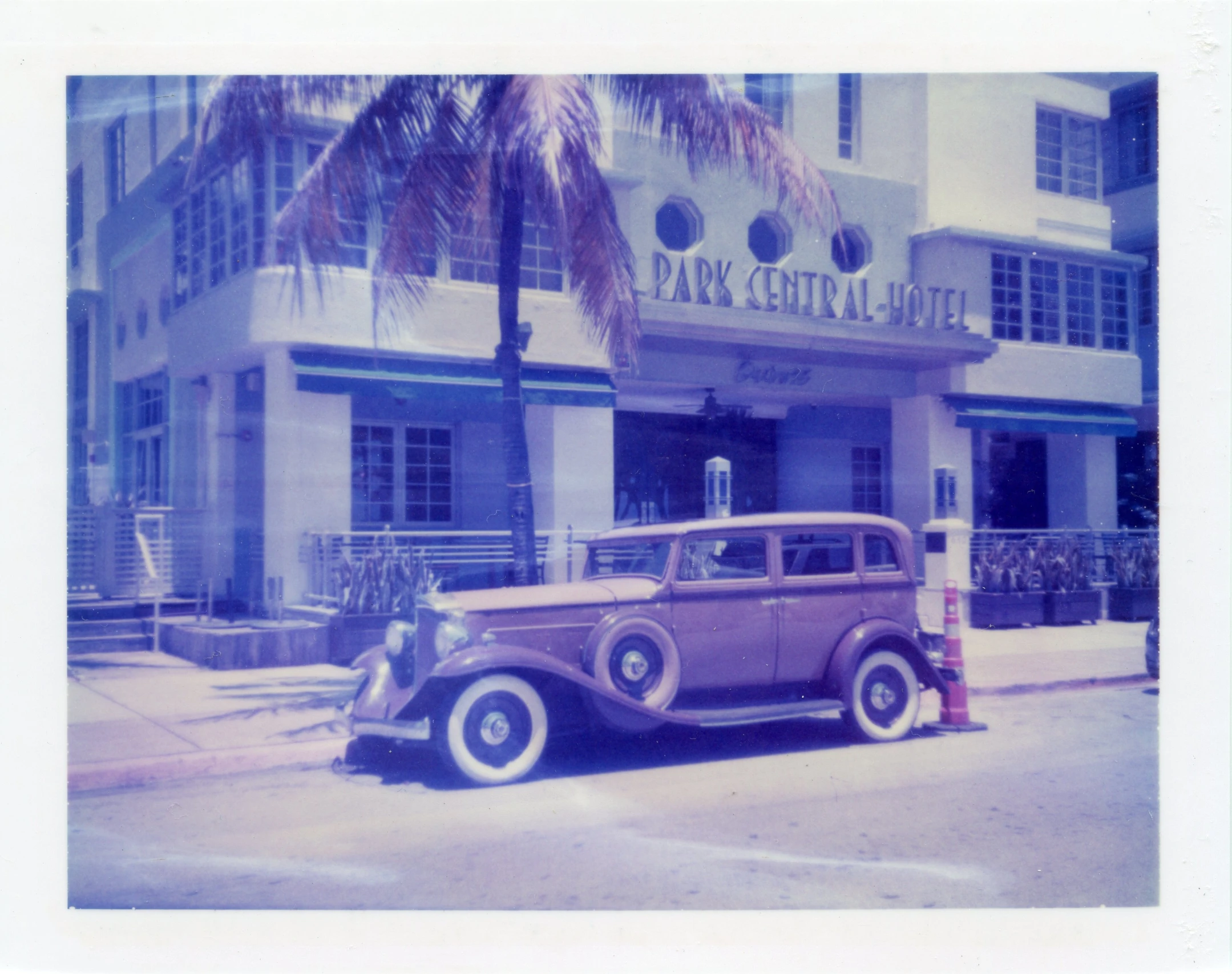 old time car parked in front of the parking spot of an upscale el