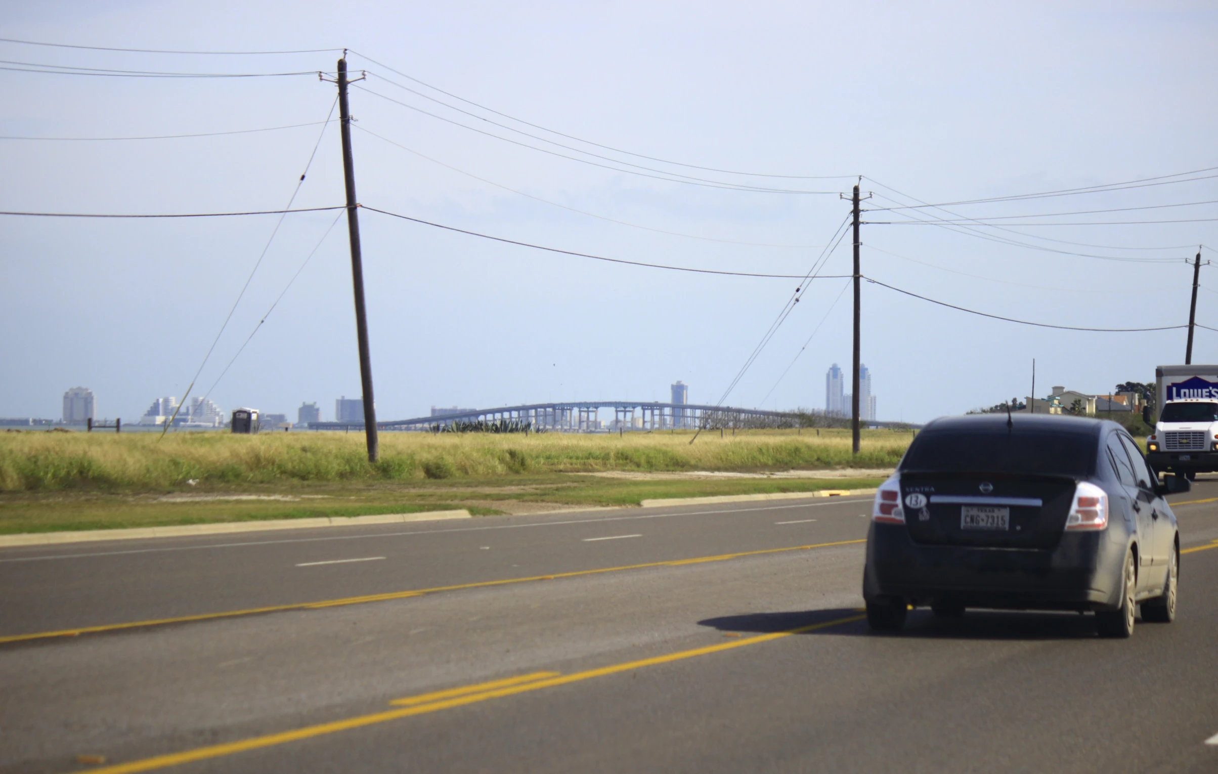 a car with its trunk in the back, driving down a highway