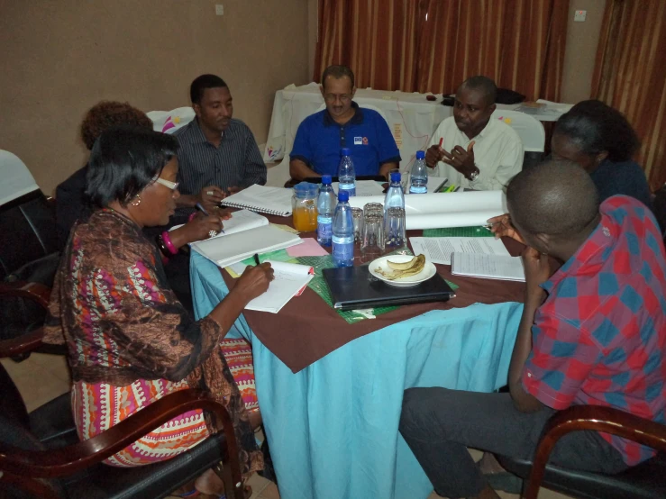 people seated around a table having a meeting