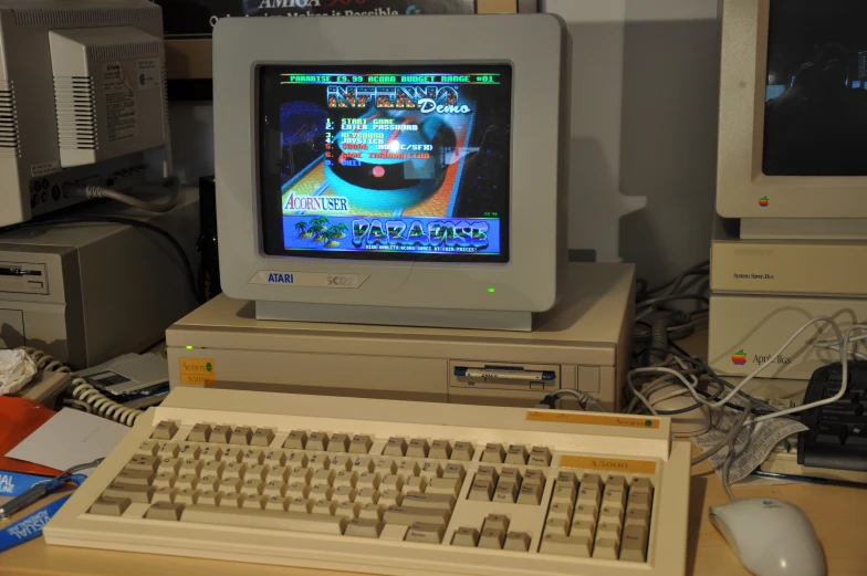 an old computer has been placed in front of a computer monitor