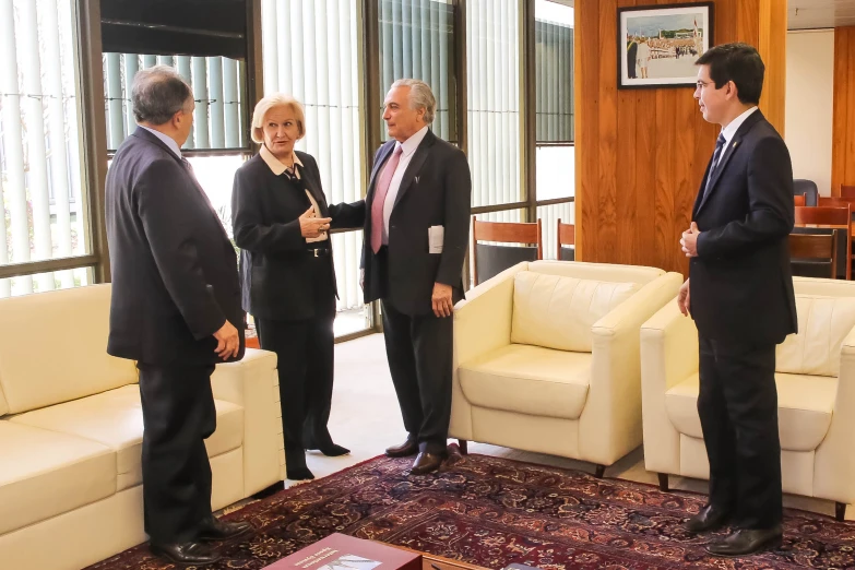 five men in suits are standing next to each other