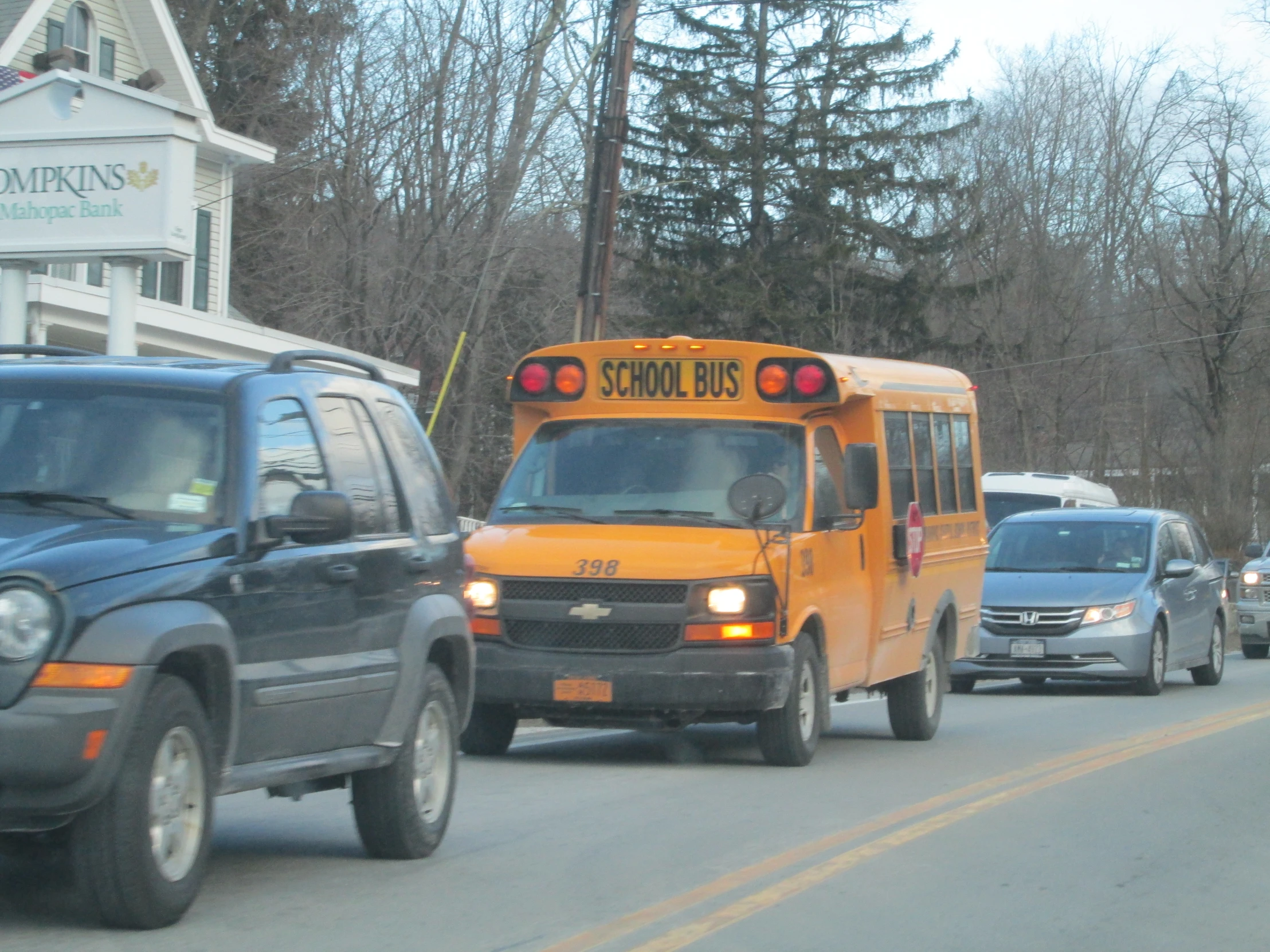 a yellow school bus going down the street