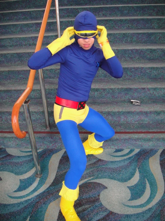 a man in costume on the stairs talking on a cell phone