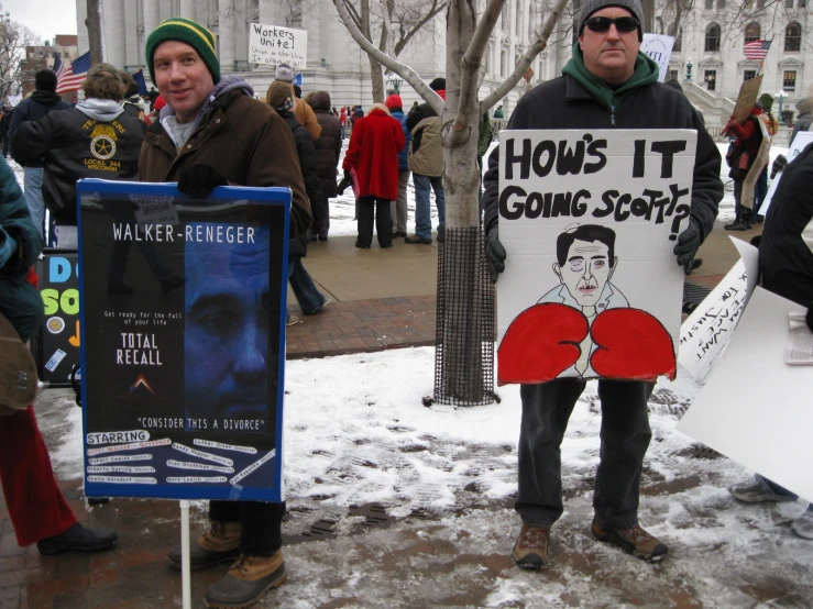 two people holding a demonstration in the snow