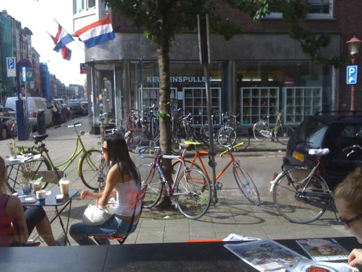 people sitting in chairs and a few bicycles