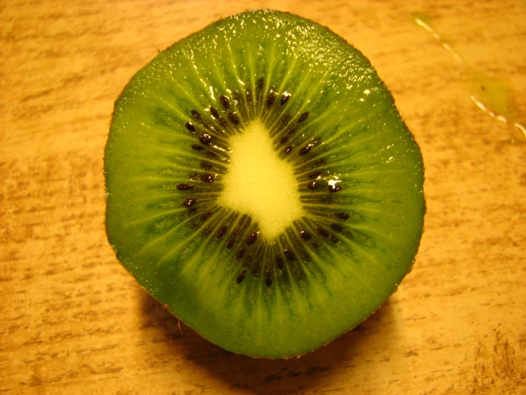 a kiwi fruit cut in half with the center slice missing